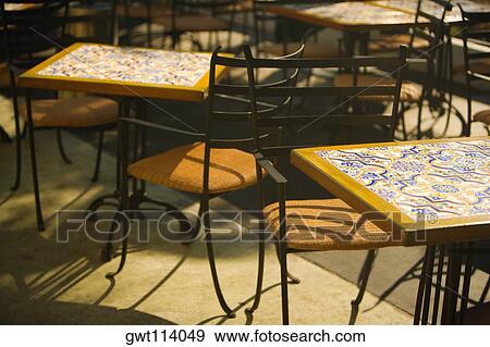 Close-up of tables and chairs at a sidewalk cafe View Large Photo Image Stock Photo - Close-up of tables and chairs at a sidewalk cafe. Fotosearch