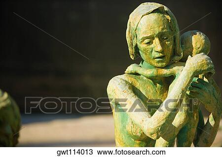 Stock Image - Close-up of the sculpture of a woman with her baby. Fotosearch