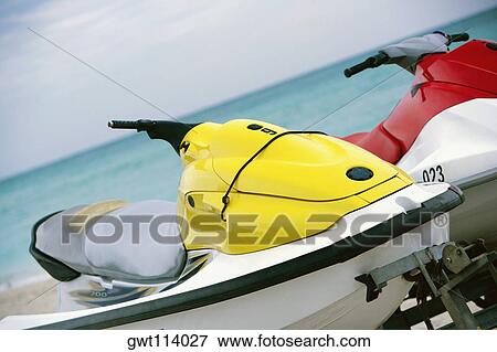 Close-up of two empty jet skis View Large Photo Image Stock Photo - Close-up of two empty jet skis. Fotosearch