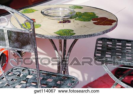 Stock Photo - High angle view of empty chairs and a table in a restaurant. Fotosearch