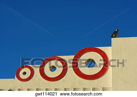 Stock Image - Low angle view of a bird perching on a wall. Fotosearch