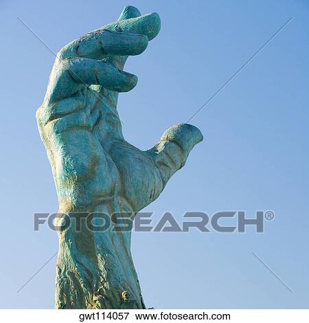 Stock Photo - Low angle view of a hand sculpture. Fotosearch