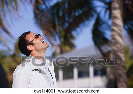 Stock Image - Side profile of a mid adult man looking up. Fotosearch