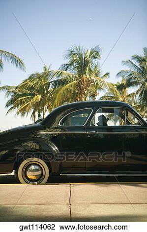 Vintage car parked on the roadside View Large Photo Image Stock Image - Vintage car parked on the roadside. Fotosearch
