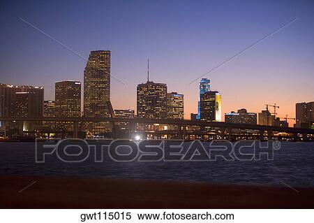 Buildings at the waterfront lit up at dusk, Miami, Florida, USA View Large Photo Image Stock Photography - Buildings at the waterfront lit up at dusk, Miami, Florida, USA. Fotosearch