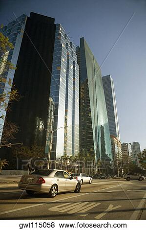Stock Photo - Cars moving on a road in front of skyscrapers, Miami, Florida, USA. Fotosearch