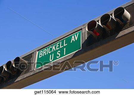 Picture - Low angle view of traffic lights with an information sign, Miami, Florida, USA. Fotosearch