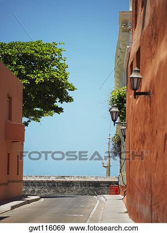 Buildings on both sides of a road, Cartagena, Colombia View Large Photo Image Stock Photo - Buildings on both sides of a road, Cartagena, Colombia. Fotosearch