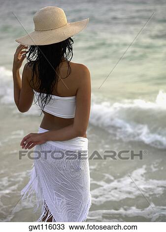 Rear view of a young woman wearing a sun hat View Large Photo Image Stock Image - Rear view of a young woman wearing a sun hat. Fotosearch