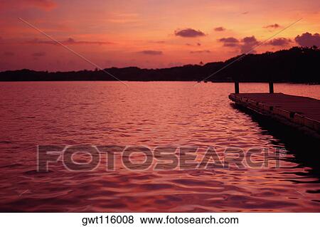 Silhouette of a pier in the sea View Large Photo Image Stock Photo - Silhouette of a pier in the sea. Fotosearch