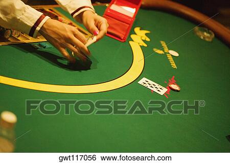 Stock Photograph - High angle view of a person's hand holding playing cards, Las Vegas, Nevada, USA. Fotosearch