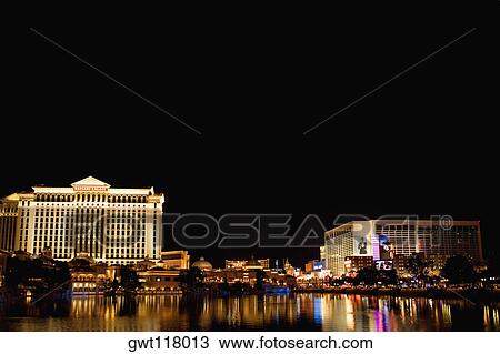 Stock Image - Buildings at the waterfront lit up at night, Las Vegas, Nevada, USA. Fotosearch