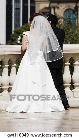 Rear view of a newlywed couple standing near a balustrade, Las Vegas, Nevada, USA View Large Photo Image Stock Photo - Rear view of a newlywed couple standing near a balustrade, Las Vegas, Nevada, USA. Fotosearch