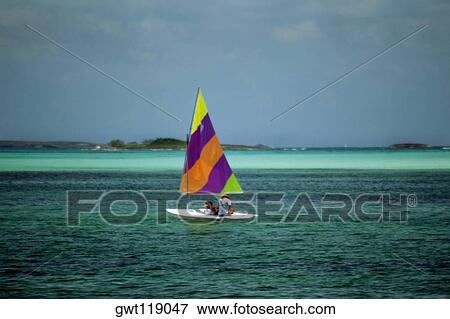 A colorful sailboat on the tranquil sea, Treasure Island, Abaco, Bahamas View Large Photo Image Stock Photo - A colorful sailboat on the tranquil sea, Treasure Island, Abaco, Bahamas. Fotosearch