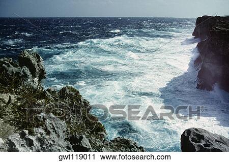 Stock Image - High angle view of waves crashing against the rocks, Clipps Window Pane, Eleuthera, Bahamas. Fotosearch