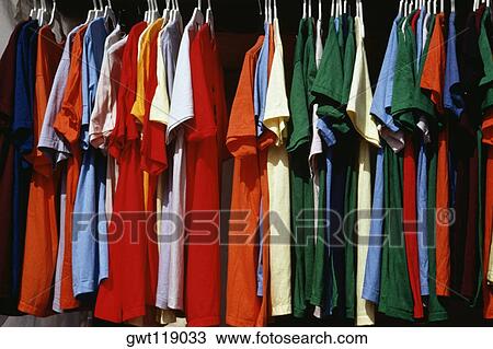Side view of a row of colorful shirts displayed at a shop, Grand Bahamas, Bahamas View Large Photo Image Stock Image - Side view of a row of colorful shirts displayed at a shop, Grand Bahamas, Bahamas. Fotosearch