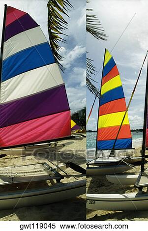 Stock Photography - Side view of colorful sailboats on a beach, Nassau, Bahamas. Fotosearch