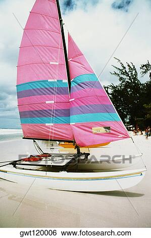 A boat with a colorful sail on a beach, Barbados View Large Photo Image Stock Photograph - A boat with a colorful sail on a beach, Barbados. Fotosearch