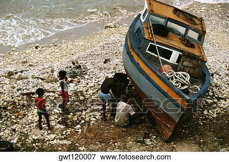 Side view of a boat being repaired near a seashore, Barbados View Large Photo Image Stock Photo - Side view of a boat being repaired near a seashore, Barbados. Fotosearch