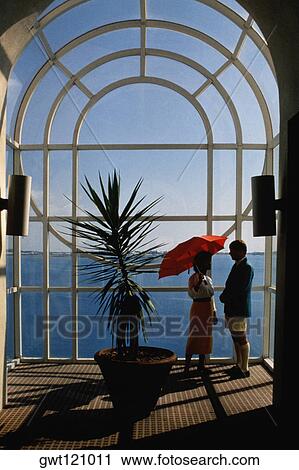 A couple is seen conversing near a plant, Bermuda portfolio, Bermuda View Large Photo Image Stock Image - A couple is seen conversing near a plant, Bermuda portfolio, Bermuda. Fotosearch