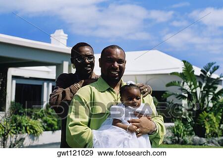 Front view of a couple holding their baby girl, Bermuda View Large Photo Image Stock Photo - Front view of a couple holding their baby girl, Bermuda. Fotosearch