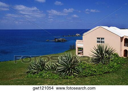 Side view of a pink building facing the ocean, Devonshire north shore, Bermuda View Large Photo Image Picture - Side view of a pink building facing the ocean, Devonshire north shore, Bermuda. Fotosearch
