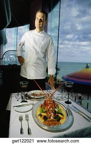 A chef stands near a garnished lobster served on a table, Crystal Palace, Sole Mara, Nassau, Bahamas View Large Photo Image Stock Image - A chef stands near a garnished lobster served on a table, Crystal Palace, Sole Mara, Nassau, Bahamas. Fotosearch