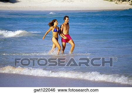 A couple running through the seawater, Horse-shoe Bay beach, Bermuda View Large Photo Image Stock Photograph - A couple running through the seawater, Horse-shoe Bay beach, Bermuda. Fotosearch