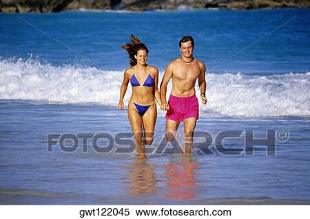 A couple running through the seawater, Horse-shoe Bay beach, Bermuda View Large Photo Image Stock Photography - A couple running through the seawater, Horse-shoe Bay beach, Bermuda. Fotosearch
