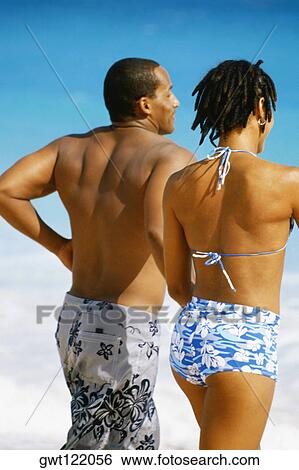 Rear view of a couple in swimsuit, Horse-shoe Bay beach, Bermuda View Large Photo Image Stock Photograph - Rear view of a couple in swimsuit, Horse-shoe Bay beach, Bermuda. Fotosearch