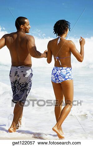 Rear view of couple in swimsuit, Horse-shoe Bay beach, Bermuda View Large Photo Image Stock Photo - Rear view of couple in swimsuit, Horse-shoe Bay beach, Bermuda. Fotosearch