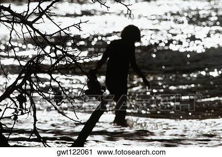 Silhouette of a person walking through water in the sea View Large Photo Image Stock Image - Silhouette of a person walking through water in the sea. Fotosearch