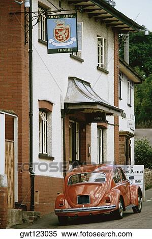 An orange car is parked outside a pub, England View Large Photo Image Stock Photography - An orange car is parked outside a pub, England. Fotosearch