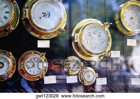 Stock Photo - Close up of brass clocks on display in Greenwich, England. Fotosearch