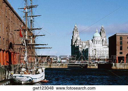 Front view of a clock tower and a boat, Liverpool, England View Large Photo Image Stock Photo - Front view of a clock tower and a boat, Liverpool, England. Fotosearch