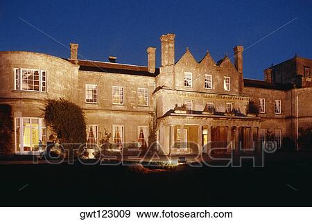 Stock Photo - Low angle view of Lucknam Park Manor House at night, Cotswold, England. Fotosearch