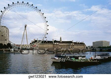 Low angle view of "The Eye" Ferris wheel and Thames River, London, England, United Kingdom View Large Photo Image Stock Image - Low angle view of "The Eye" Ferris wheel and Thames River, London, England, United Kingdom. Fotosearch