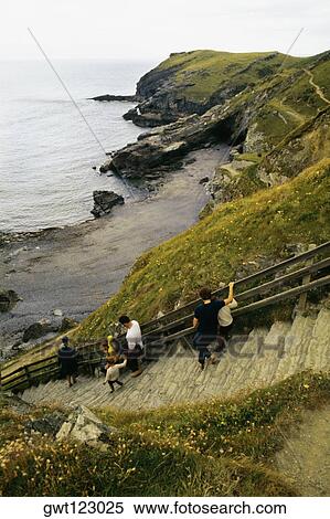 People are seen walking down steps from King Arthur's castle to a beach in England View Large Photo Image Stock Photography - People are seen walking down steps from King Arthur's castle to a beach in England. Fotosearch