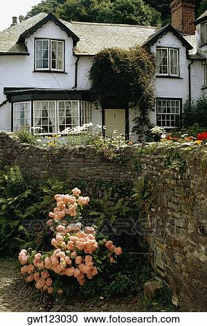 Side view of a house with a garden in its front, England View Large Photo Image Stock Image - Side view of a house with a garden in its front, England. Fotosearch