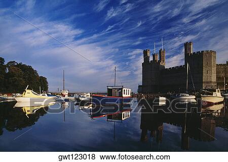 Stock Photo - Side view of Caernarvon Castle from a river in Wales. Fotosearch