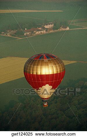 Aerial view of a hot air balloon over a verdure, Burgundy, France View Large Photo Image Stock Photography - Aerial view of a hot air balloon over a verdure, Burgundy, France. Fotosearch