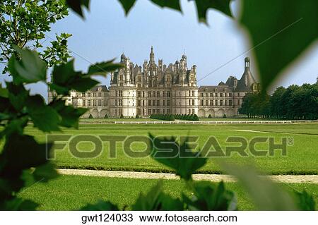 Distant view of a castle through a foliage, Loire Valley, France View Large Photo Image Stock Image - Distant view of a castle through a foliage, Loire Valley, France. Fotosearch