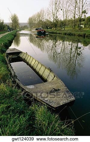 High angle of an old boat with a barge moving upstream, Burgundy Canal, France View Large Photo Image Stock Photo - High angle of an old boat with a barge moving upstream, Burgundy Canal, France. Fotosearch