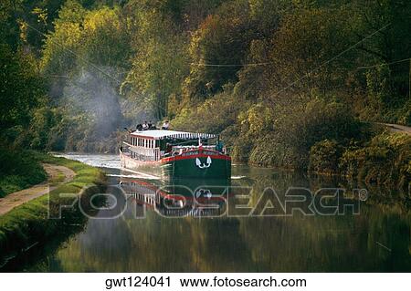 Side view of a luxury barge moving upstream, France View Large Photo Image Stock Image - Side view of a luxury barge moving upstream, France. Fotosearch