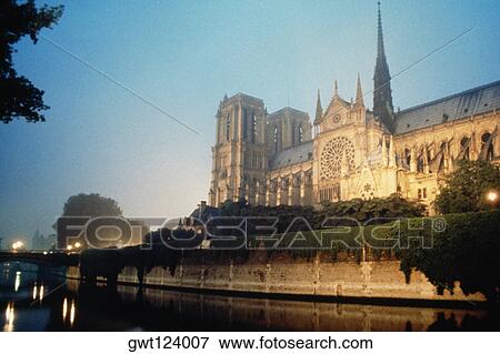 Side view of Notredame Cathedral near a river, Paris, France View Large Photo Image Stock Photo - Side view of Notredame Cathedral near a river, Paris, France. Fotosearch