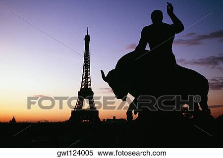 Stock Photography - Silhouette of a statue with Eiffel tower and Eid Alliot Palace in the background, France. Fotosearch