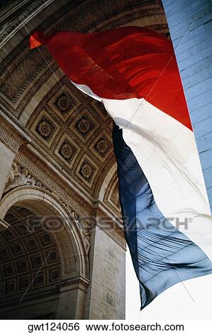 Tri-color flag fluttering under Arc De Triomphe, Paris, France View Large Photo Image Stock Photograph - Tri-color flag fluttering under Arc De Triomphe, Paris, France. Fotosearch
