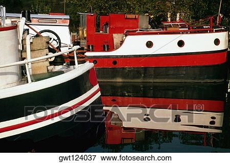 Two river barges dry-docked on a calm river, France View Large Photo Image Stock Photo - Two river barges dry-docked on a calm river, France. Fotosearch