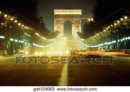 Stock Image - View of the Arc De. Triomphe at night, Paris, France. Fotosearch