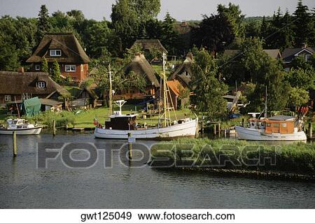 Stock Photo - Fishing boats moored at a port, Lubeck Port, Germany. Fotosearch